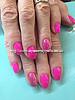 Pink polish with glitter ring fingers over acrylic nails