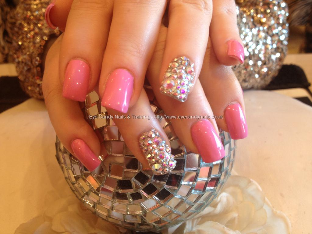 Acrylic nails with pink polish and Swarovski crystals on ring finger # ...