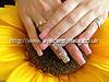 Acrylic nails with pink gel polish and Swarovski crystal