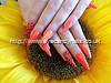 Stiletto nails with orange gel polish and zebra print nail art