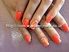 Acrylic nails with orange gel polish and Swarovski crystals on ring finger